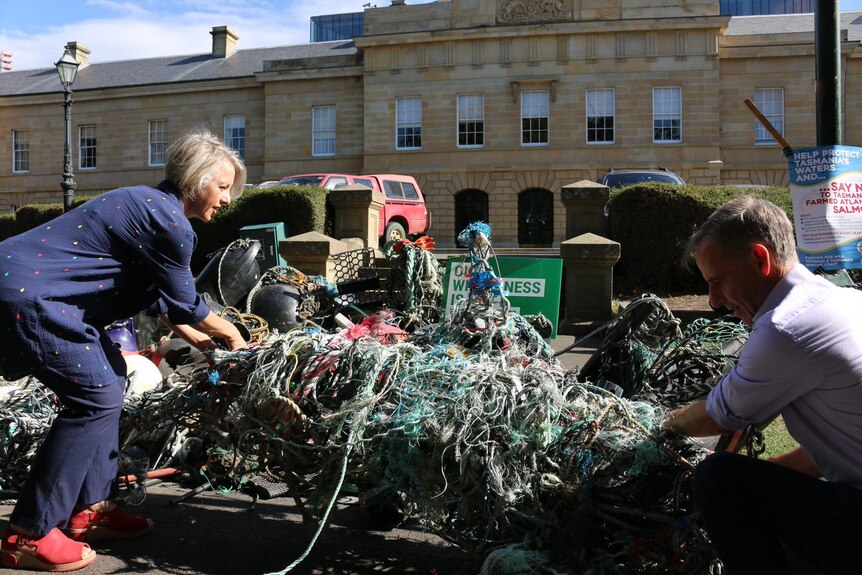 Greens Senator Nick McKim showing marine debris.