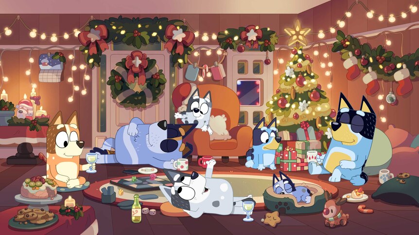 Bluey and family lie around the Christmas tree contentedly with decorations everywhere.