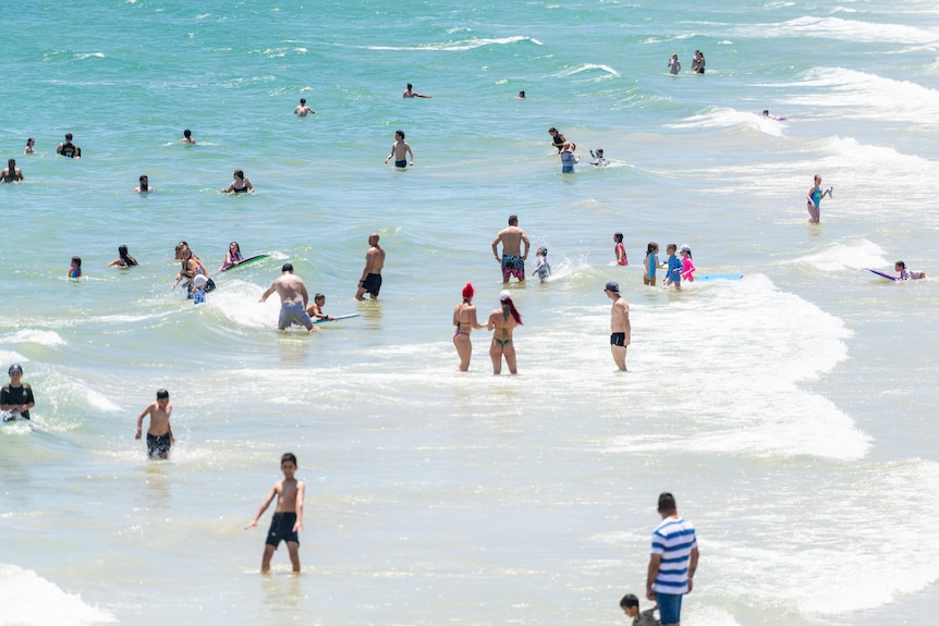 People swim at a beach in Adelaide.