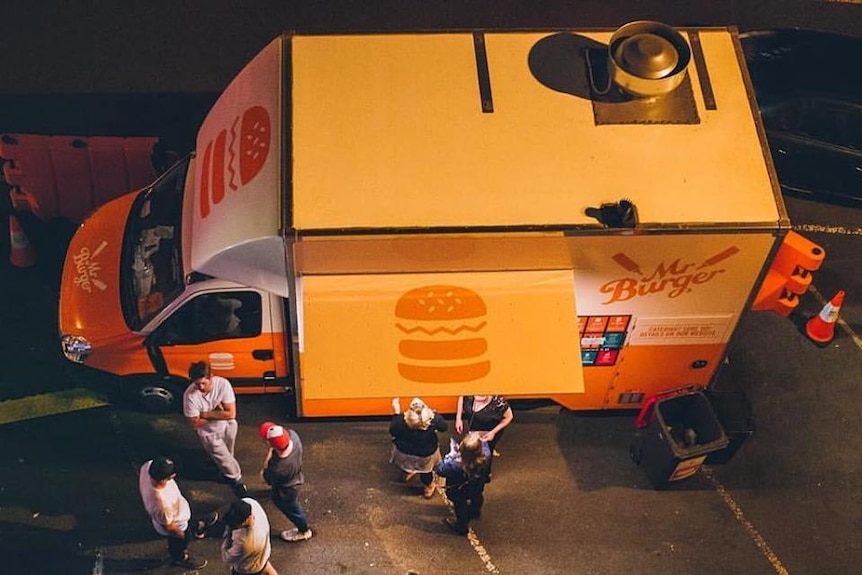 People standing around a food van in Tasmania.