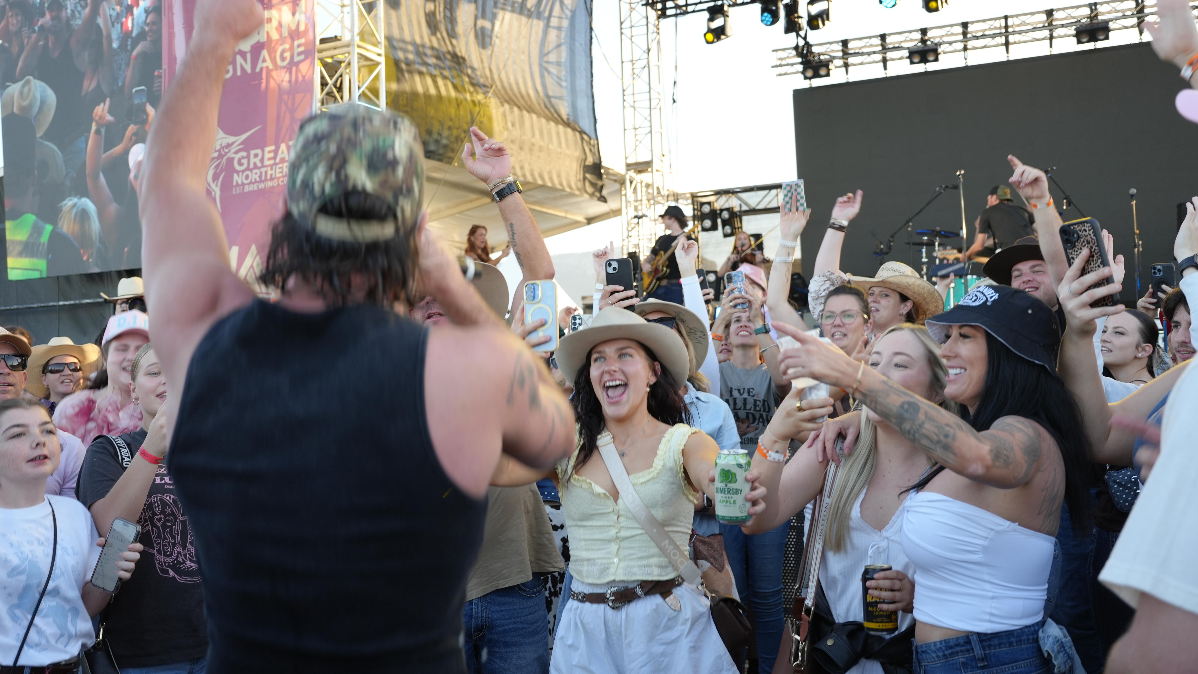 musician facing crowd of young people dancing at concert