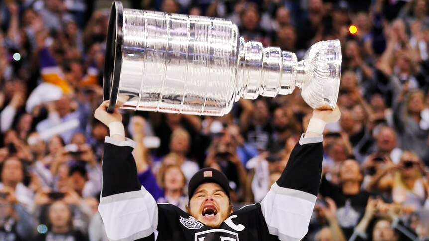 Los Angeles Kings captain Dustin Brown hoists the Stanley Cup after his team's maiden title win.