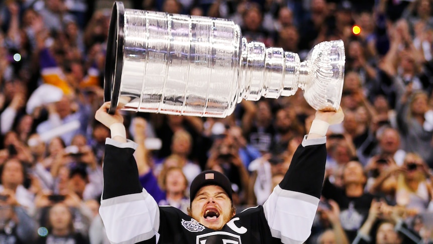 Los Angeles Kings captain Dustin Brown hoists the Stanley Cup after his team's maiden title win.