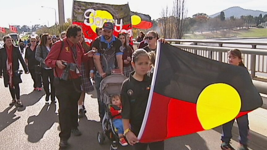Families and school children were among the crowd which turned out to the bridge walk in Canberra.
