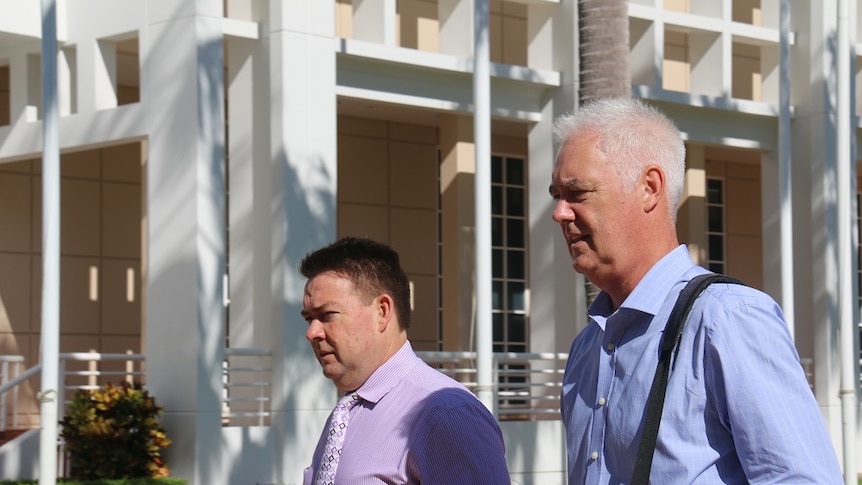 Lawyer Anthony Elliot and former commissioner John McRoberts walking outside