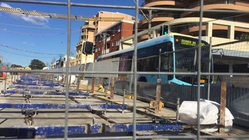 Transport construction with a bus behind it.