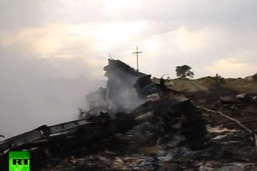 A YouTube clip shows smoke rising from debris from the MH17 crash.