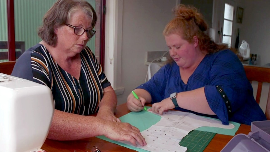 Annette Whitemore, with her daughter Keelie McMahon seated at a table.