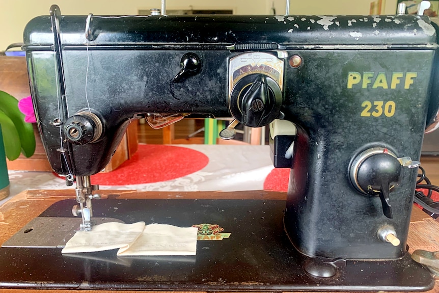 Old black sewing machine with branding PFAFF 230