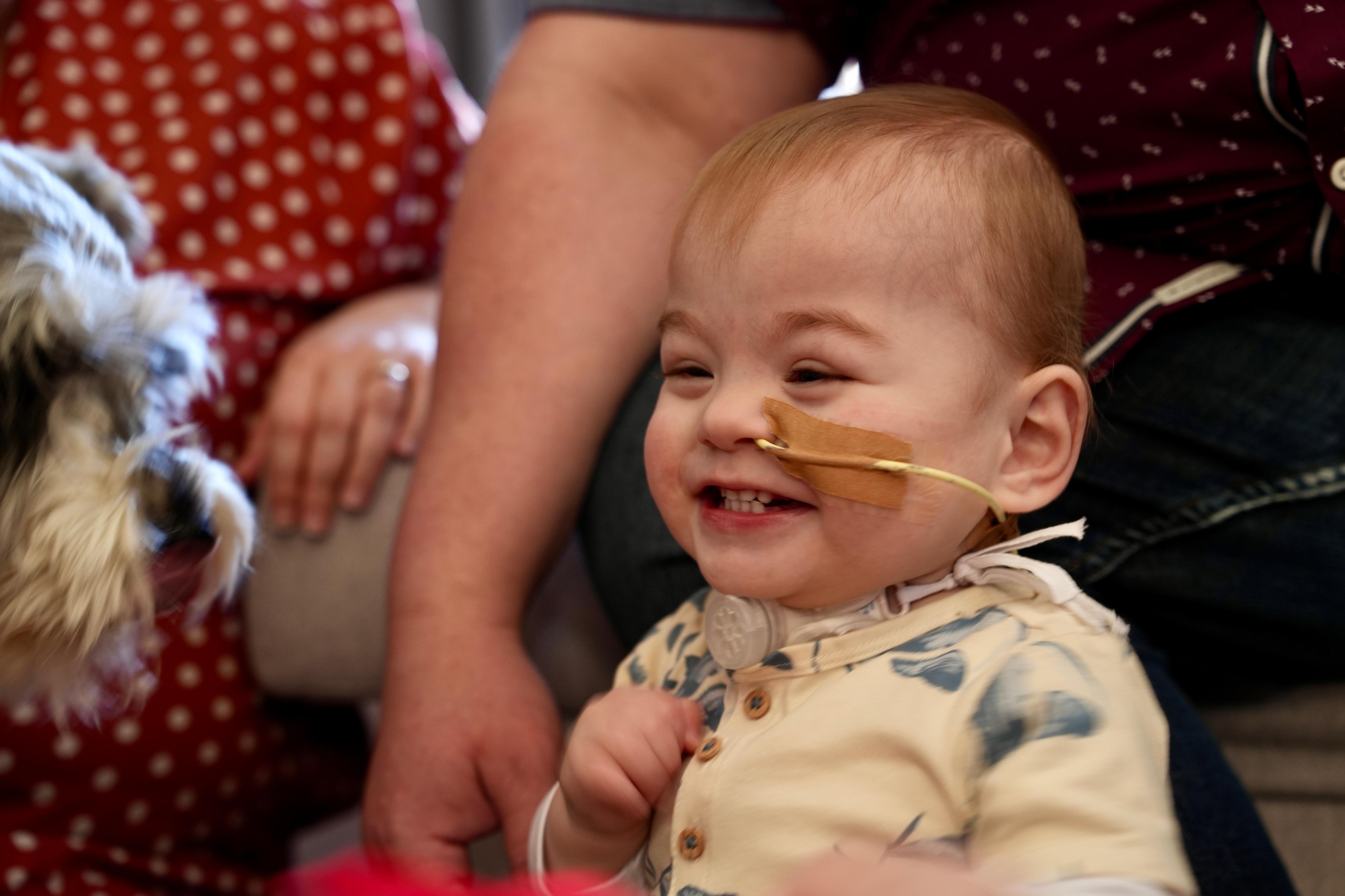 Atticus, who is 18 months old, smiles from ear to ear.