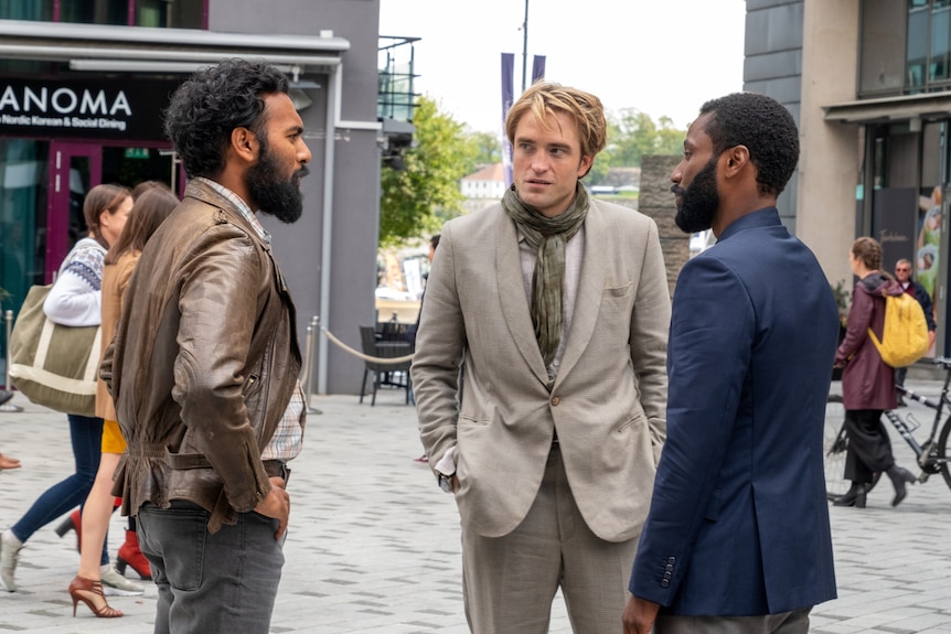 John David Washington and Robert Pattinson confront each other in a scene from the film Tenet