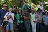 Owners with nine backpackers at Sutherland Station posing for a photo under the shade of a tree