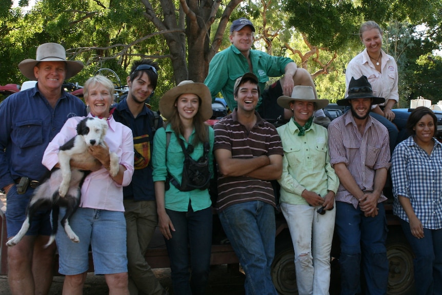 The team of 11 at Sutherland Station in 2014 posing for a photo under the shade of a tree