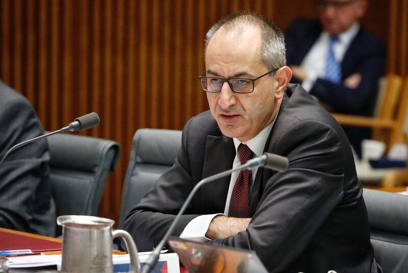 Mike Pezzullo speaking at the Senate estimates with a serious expression.