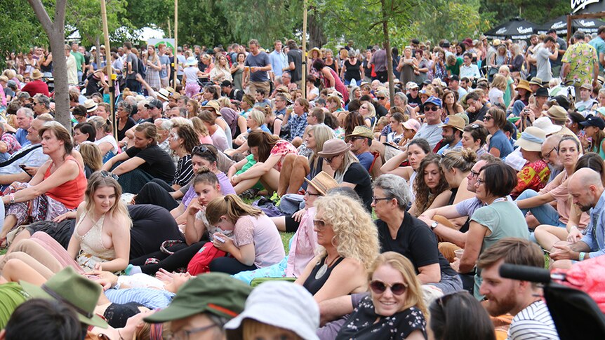 Hundreds of people sitting at the WOMADelaide festival in Adelaide