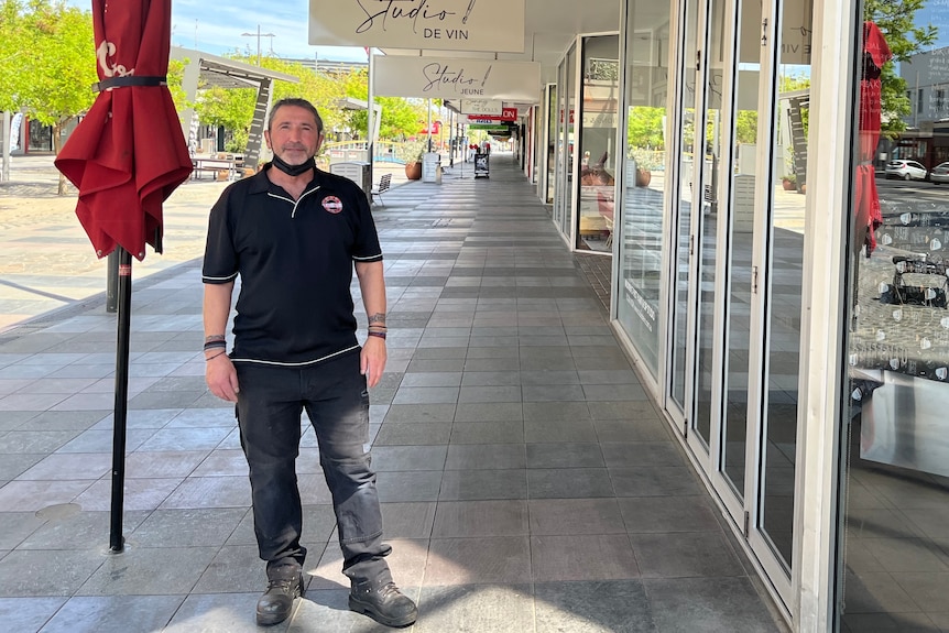 Cafe manager John Kimerlis stands outside his business 