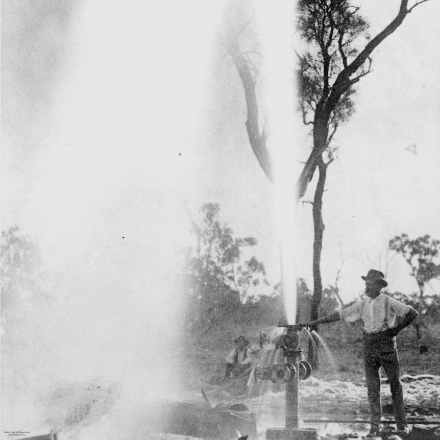 A man stands beside an artesian bore near Barcaldine in 1894