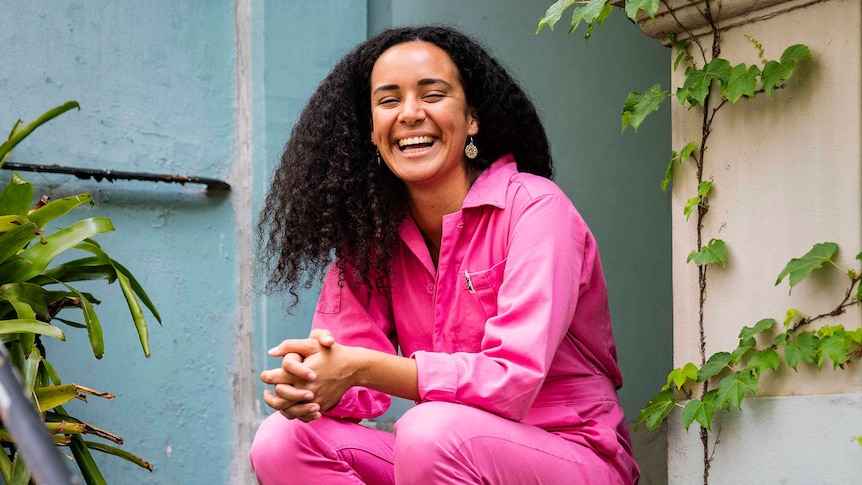 Gemma Bird Matheson smiling, with jasmine bush in background.