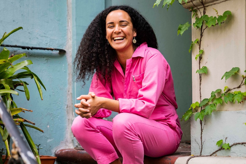 Gemma Bird Matheson smiling, with jasmine bush in background.