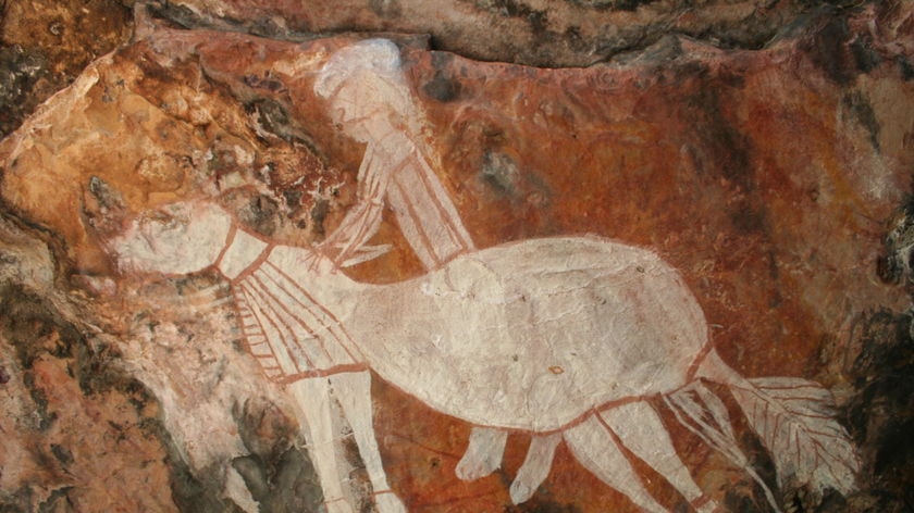 Artwork on a rock which shows a horse and rider