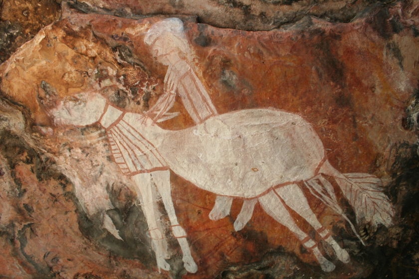 Artwork on a rock which shows a horse and rider