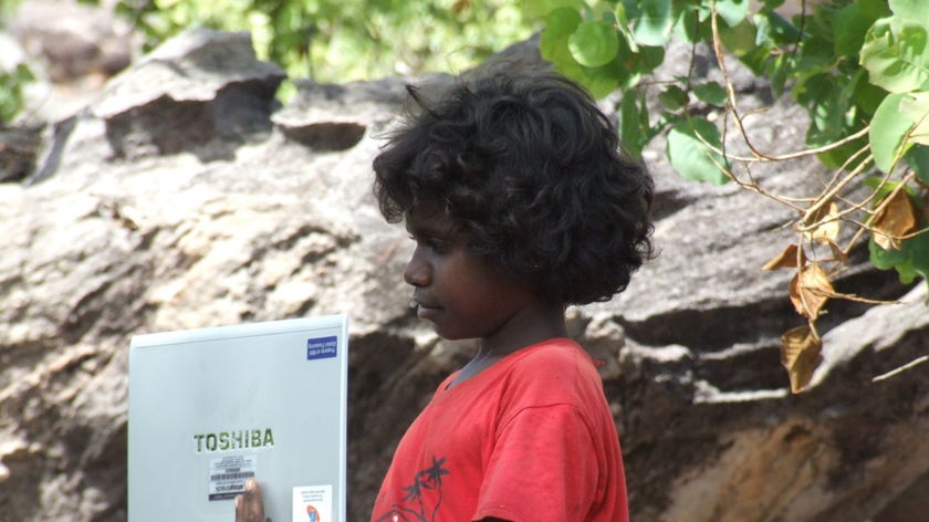 Aboriginal boy with laptop computer, Arnhem Land, NT, December 2008
