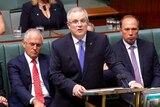 Scott Morrison delivers the budget with Malcolm Turnbull behind him