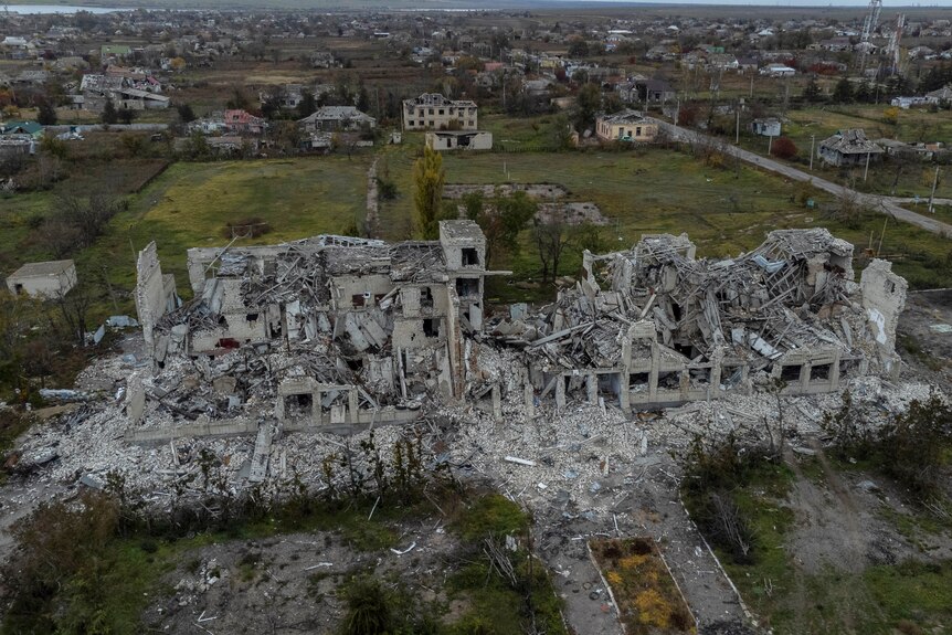 A view from above of a school destroyed, with walls crumbled. 