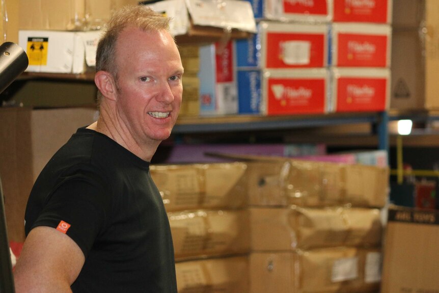 Samm Harrington, owner of ToyWorld Hobart, in his storeroom.