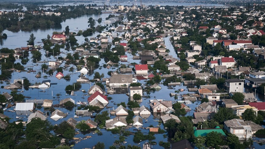 Homes are seen among flood waters that have totally covered streets, leaving only the upper parts of buildings above water.
