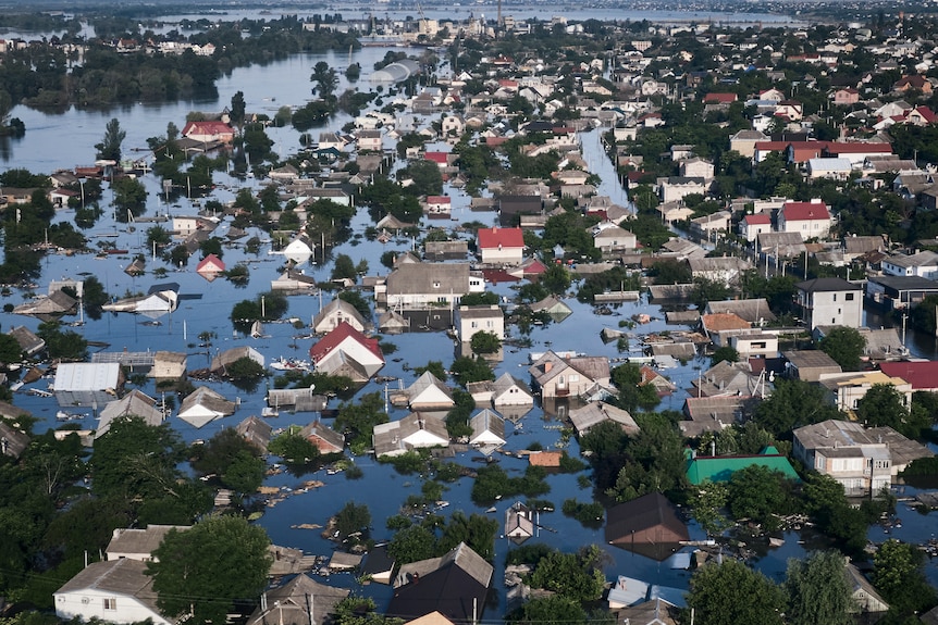 Homes are seen among flood waters that have totally covered streets, leaving only the upper parts of buildings above water.