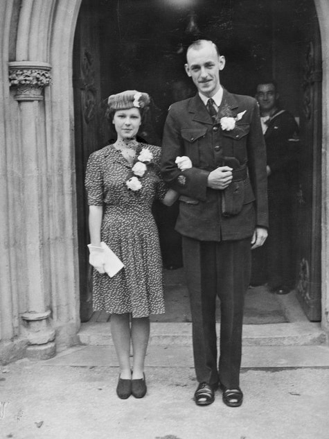 A historic photograph of a World War soldier arm-in-arm with a woman.