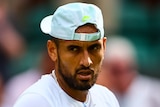 An Australian male tennis players looks to his right after winning Wimbledon quarterfinal.