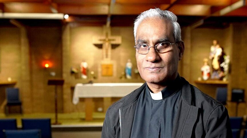 Father Albert Yogarajah pictured in a church.