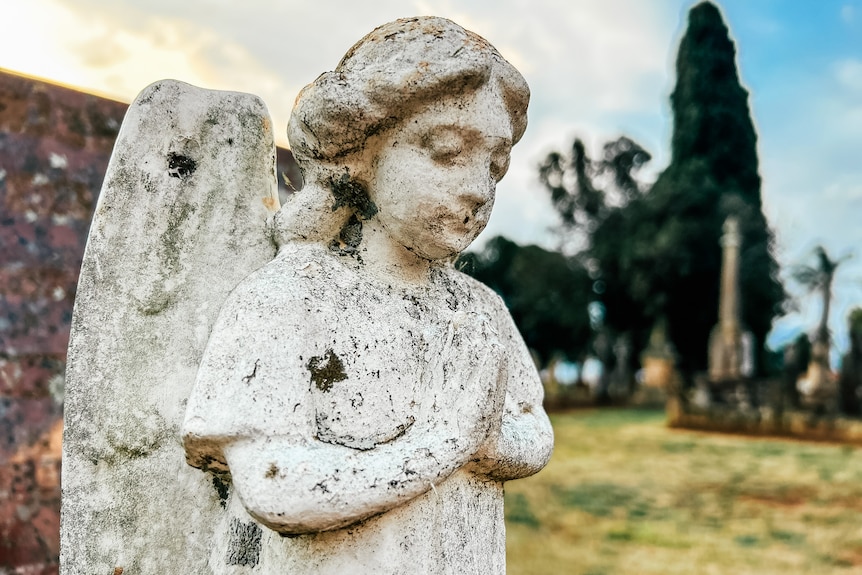 an angel monument in a cemetery