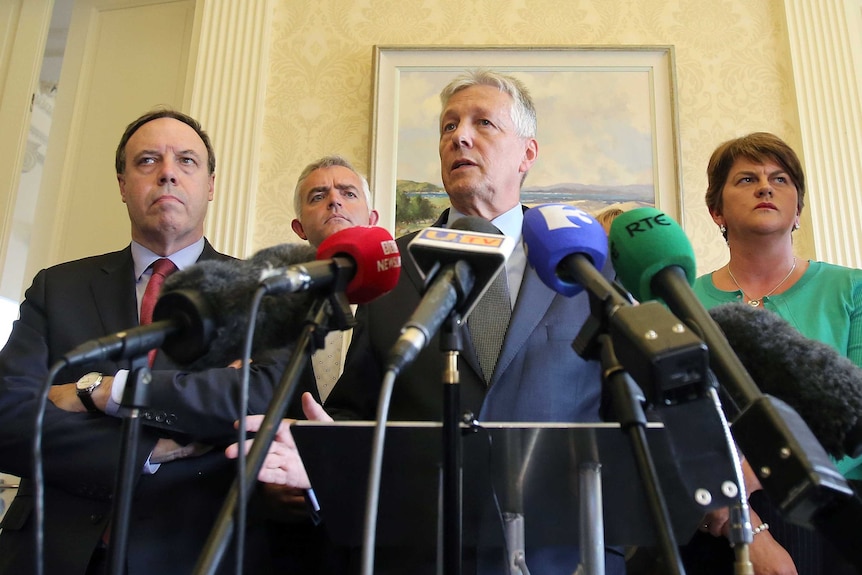 Northern Ireland first minister Peter Robinson addresses the media