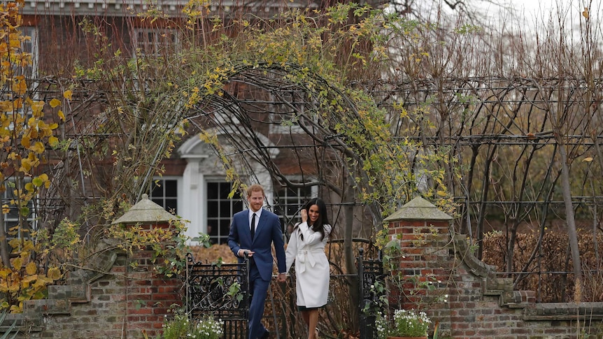 Britain's Prince Harry and his fiancee Meghan Markle in the grounds of Kensington Palace.