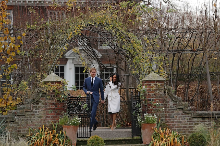 Britain's Prince Harry and his fiancee Meghan Markle in the grounds of Kensington Palace.