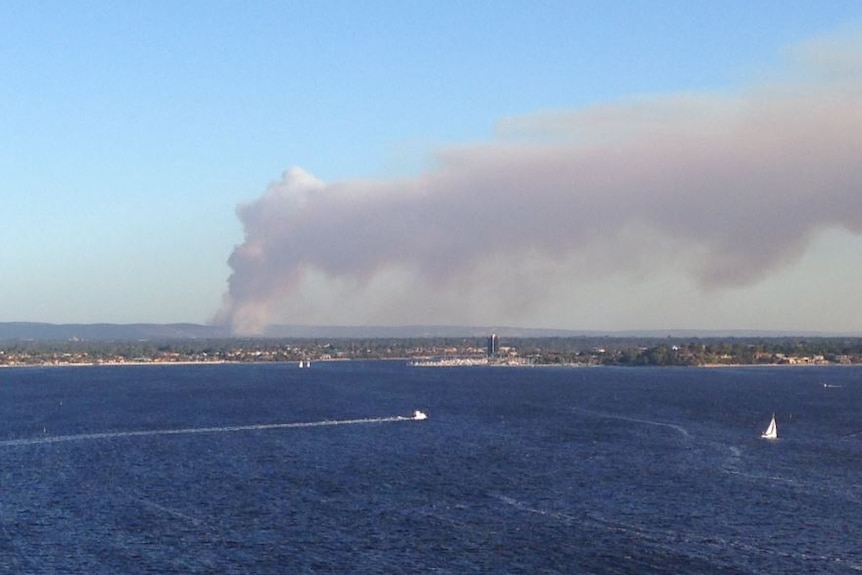 A smoke plume rises in Perth's south east, over the river.