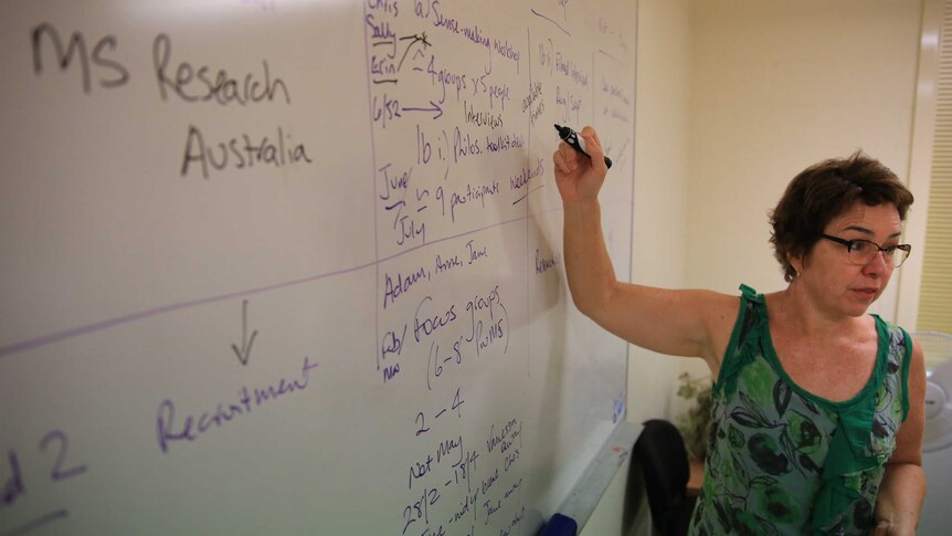 Dr Jane Desborough points at a whiteboard while teaching a class.