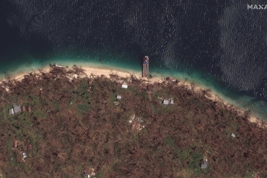 Destroyed forest and a ship can be seen from above along the shore line.