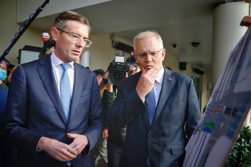 Dominic Perrottet and Scott Morrison look at artist impressions of a bridge upgrade. 