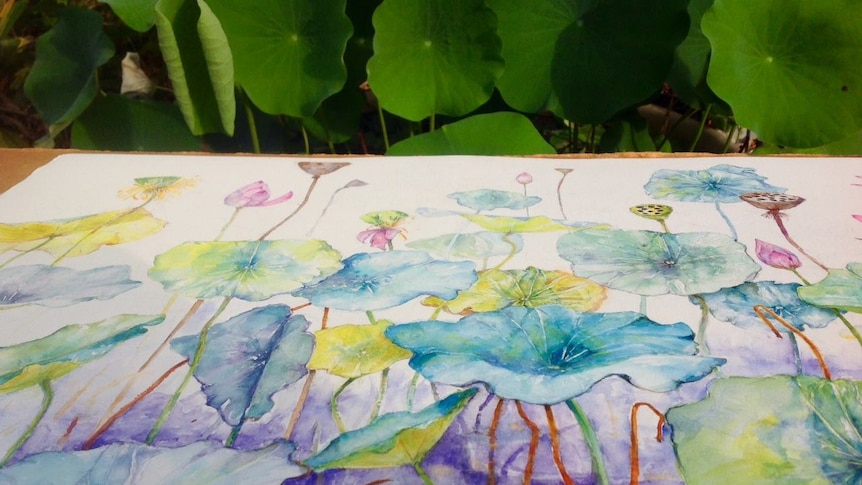 watercolour of lotus with real lotus in background