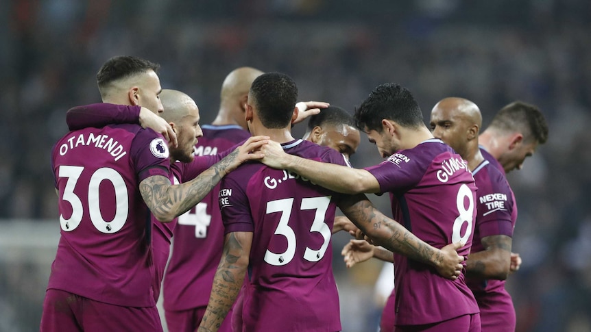 Manchester City players celebrate scoring goal at Wembley