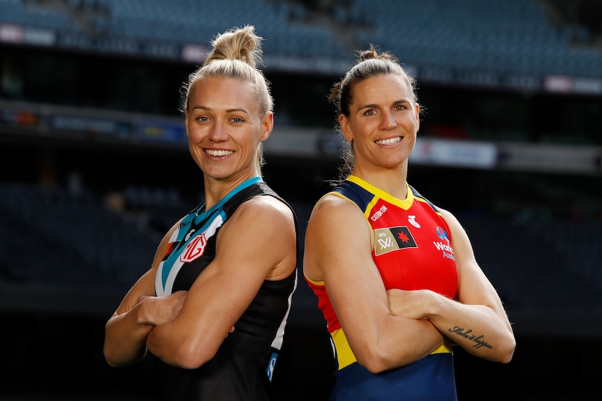 Erin Phillips and Chelsea Randall stand back to back with arms crossed, smiling.