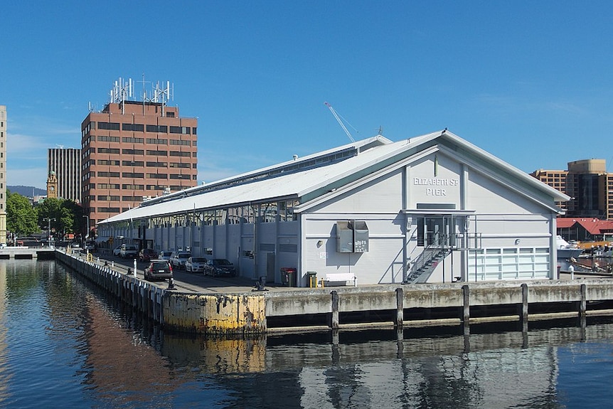 A pier with building extends over water.