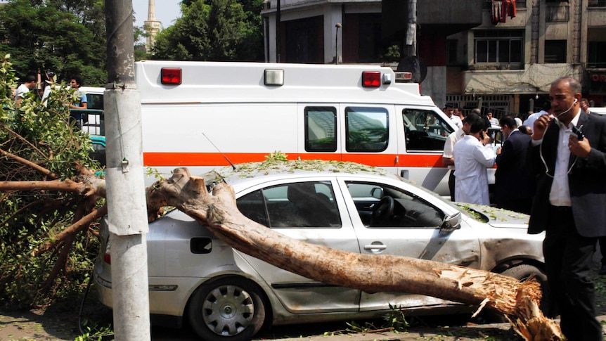 The blast caused a tree to fall on a car.