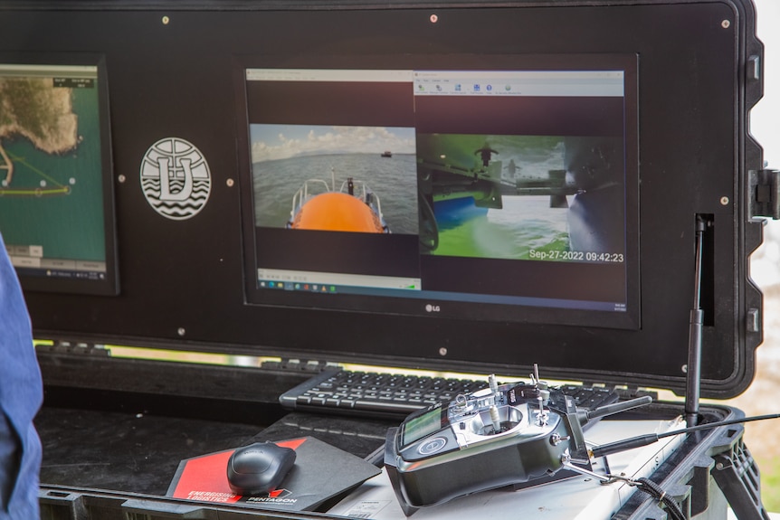 Computer screens displaying feeds from cameras on board autonomous boat. 