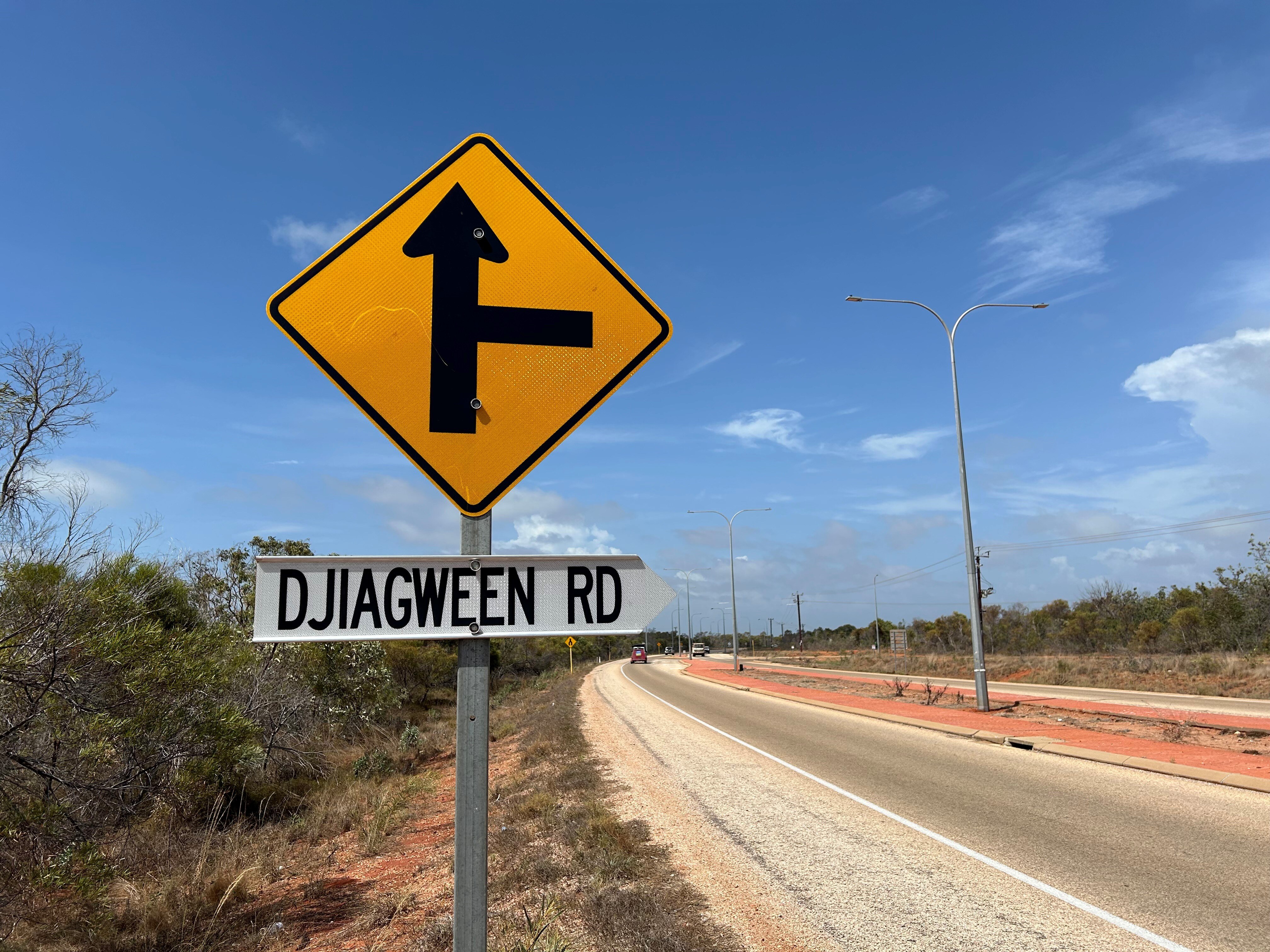 A road sign on the side reading Djiagween Road