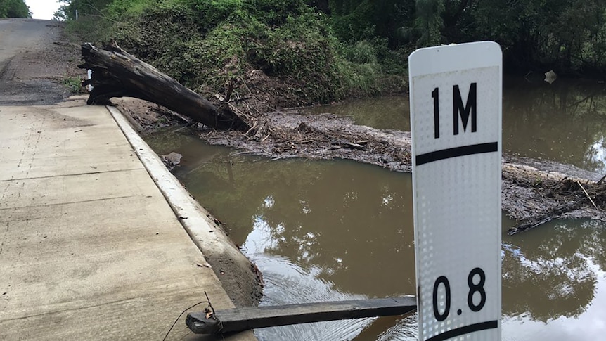 Creek causeway with flood sign showing it is prone to flash flooding